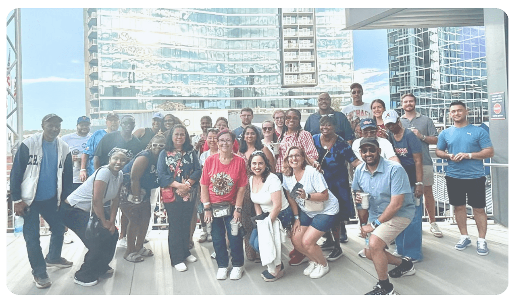 A group of Iuvo Systems employees gathered at the 2025 Townhall, engaging in discussions and celebrating company milestones