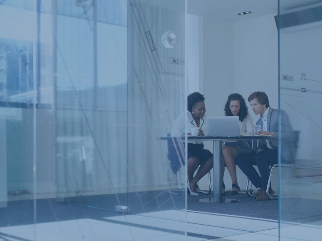 Staffing image of three people sitting in a conference room with tech overlay